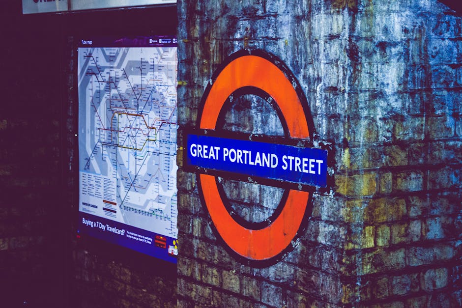 Image of the Great Portland Street London Underground sign next to a transit map.
